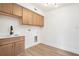 Laundry room with wood cabinets, modern sink and faucet, and vinyl floor at 291 Lamplighter Se Ln, Marietta, GA 30067
