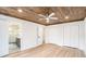Main bedroom with wood ceiling, ceiling fan, and ensuite bathroom with glass shower at 291 Lamplighter Se Ln, Marietta, GA 30067