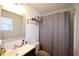 Full bathroom with a sleek vanity, decorative towel rack, and a shower with a neutral curtain at 671 Benson Hurst Sw Dr, Mableton, GA 30126