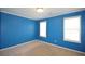 This bedroom has two windows providing natural light and neutral carpeting for added comfort and versatile decor options at 671 Benson Hurst Sw Dr, Mableton, GA 30126