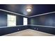 Bedroom with dark walls, two windows, and carpet flooring at 671 Benson Hurst Sw Dr, Mableton, GA 30126