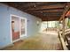 The spacious covered porch is perfect for relaxing with comfortable seating and a tranquil wooded backdrop, lit by string lights at 671 Benson Hurst Sw Dr, Mableton, GA 30126
