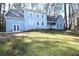 Inviting blue two-story home featuring well-maintained lawn and classic architectural details at 671 Benson Hurst Sw Dr, Mableton, GA 30126