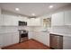 Modern kitchen featuring stainless steel appliances, white cabinetry, and a tile backsplash at 671 Benson Hurst Sw Dr, Mableton, GA 30126