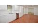 Well-lit kitchen showcasing white cabinets, tile flooring, stainless steel appliances, and ample counter space at 671 Benson Hurst Sw Dr, Mableton, GA 30126