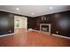 Dark toned living room featuring a brick fireplace and tile floors at 671 Benson Hurst Sw Dr, Mableton, GA 30126