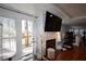 Cozy living room with a fireplace, television, and access to the back deck at 671 Benson Hurst Sw Dr, Mableton, GA 30126