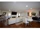 Open-concept living space with a white couch, fireplace, adjacent dining area, and hardwood floors at 671 Benson Hurst Sw Dr, Mableton, GA 30126