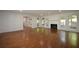 Spacious living room with gleaming hardwood floors, a fireplace, and multiple windows with natural light at 671 Benson Hurst Sw Dr, Mableton, GA 30126