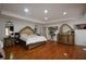 Spacious main bedroom featuring hardwood floors, a tray ceiling, and a walk-in closet at 671 Benson Hurst Sw Dr, Mableton, GA 30126