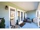 Charming covered porch with cozy seating area, stylish decor, and a welcoming atmosphere at 671 Benson Hurst Sw Dr, Mableton, GA 30126
