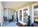 Relaxing covered porch with comfortable seating, tasteful decor, and bright natural light at 671 Benson Hurst Sw Dr, Mableton, GA 30126