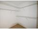 Empty walk-in closet with built-in shelving and carpet at 671 Benson Hurst Sw Dr, Mableton, GA 30126