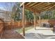 Backyard featuring a concrete patio beneath a deck, enclosed by a wooden fence and trees at 1016 Parkmont Way, Decatur, GA 30033