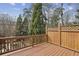 Wooden deck area with a lattice railing that offers a view of the surrounding trees at 1016 Parkmont Way, Decatur, GA 30033