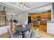 Dining area connects to the stairway and kitchen, featuring hardwood floors and a modern light fixture at 1016 Parkmont Way, Decatur, GA 30033