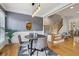 Dining area connects to the stairway, featuring hardwood floors and a modern light fixture at 1016 Parkmont Way, Decatur, GA 30033