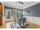 Modern dining area features a gray accent wall, a round table, and stylish pendant lighting at 1016 Parkmont Way, Decatur, GA 30033