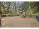 Fully fenced community dog park featuring gravel, a bench, and mature shade trees at 1016 Parkmont Way, Decatur, GA 30033