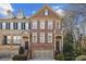 Charming brick townhome featuring a well-manicured front yard and an attached two-car garage at 1016 Parkmont Way, Decatur, GA 30033