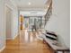 Sunlit hallway leads to the dining area, featuring hardwood floors and a decorative bench at 1016 Parkmont Way, Decatur, GA 30033