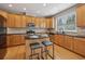 The kitchen features oak cabinets, a black countertop, and a central island with bar stools at 1016 Parkmont Way, Decatur, GA 30033