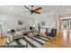 Bright living room boasts a ceiling fan, a gray sectional sofa, and a stylish decorative rug at 1016 Parkmont Way, Decatur, GA 30033