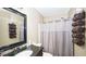 Cozy bathroom featuring a single sink, framed mirror, and shower with gray curtain at 1049 Fieldstone Dr, Canton, GA 30114