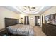 Carpeted primary bedroom featuring a tray ceiling, ceiling fan, and ample natural light at 1049 Fieldstone Dr, Canton, GA 30114