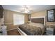 Bedroom featuring carpeted floors, a ceiling fan, and lots of natural light from the window at 1049 Fieldstone Dr, Canton, GA 30114