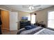 This bedroom has great natural lighting, a ceiling fan, and neutral colored walls at 1049 Fieldstone Dr, Canton, GA 30114