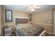 Cozy carpeted bedroom featuring a ceiling fan, neutral walls, and minimal decor at 1049 Fieldstone Dr, Canton, GA 30114