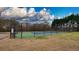 Community tennis court is surrounded by a black fence at 1049 Fieldstone Dr, Canton, GA 30114