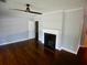 Cozy living room with hardwood floors, a ceiling fan and a fireplace at 1624 Beatie Ave, Atlanta, GA 30310