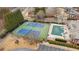 Aerial view of community tennis courts and pool with surrounding residences and landscaping at 2620 Milford Ln, Alpharetta, GA 30009