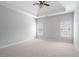 Bedroom features neutral carpet, ceiling fan, bright windows, and light grey walls at 2620 Milford Ln, Alpharetta, GA 30009