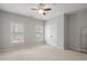 Bedroom features a ceiling fan, neutral carpet, large windows, and closet for ample storage at 2620 Milford Ln, Alpharetta, GA 30009