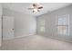 Bedroom shows two bright windows, neutral carpet, ceiling fan and white painted walls at 2620 Milford Ln, Alpharetta, GA 30009