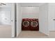 Laundry area with adjacent laundry machines, closet, and doorway to another room at 2620 Milford Ln, Alpharetta, GA 30009