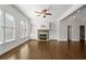 Spacious living room with fireplace, built-in shelves, large windows, and hardwood floors at 2620 Milford Ln, Alpharetta, GA 30009