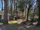 View of backyard with a well maintained lawn, surrounded by trees and greenery on a sunny day at 5169 Oxbow Rd, Stone Mountain, GA 30087