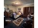 Spacious bedroom featuring natural light, ceiling fan, and dark wood furniture at 5169 Oxbow Rd, Stone Mountain, GA 30087