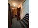 Entryway with wooden door, coat closet, and carpeted staircase, showing signs of wear and clutter at 5169 Oxbow Rd, Stone Mountain, GA 30087