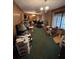 Cluttered living room showcases wood paneling, a brick feature wall, and an abundance of furniture and belongings at 5169 Oxbow Rd, Stone Mountain, GA 30087