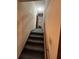 Carpeted stairway leads to the upper level, featuring a simple design and minimal decor at 5169 Oxbow Rd, Stone Mountain, GA 30087