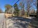 View of a home with covered parking, driveway, and surrounding trees from the street at 5169 Oxbow Rd, Stone Mountain, GA 30087