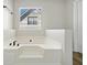 Corner bathtub featuring a jacuzzi and window with views of the exterior at 826 Shore Dr, Lithonia, GA 30058