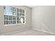 Cozy bedroom featuring neutral carpet, paint, and a large window at 826 Shore Dr, Lithonia, GA 30058