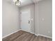 Hallway featuring modern flooring, fresh paint, bright lighting, and natural light from the front door at 826 Shore Dr, Lithonia, GA 30058