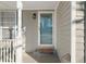 Close up of front door, side window with white trim, decorative exterior light, and grey siding at 826 Shore Dr, Lithonia, GA 30058